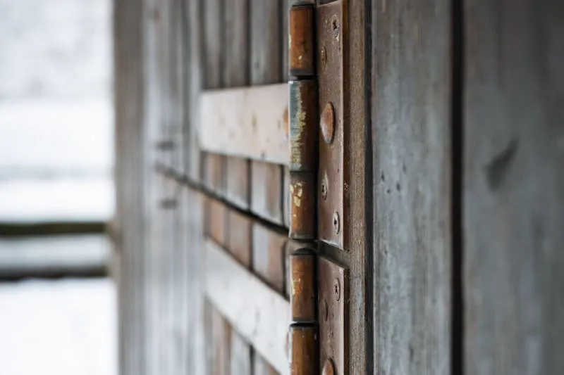 Dime held against a door hinge corner to test for quarter-inch radius