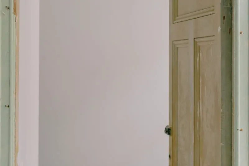 Close-up of a loose top hinge on a sagging interior door